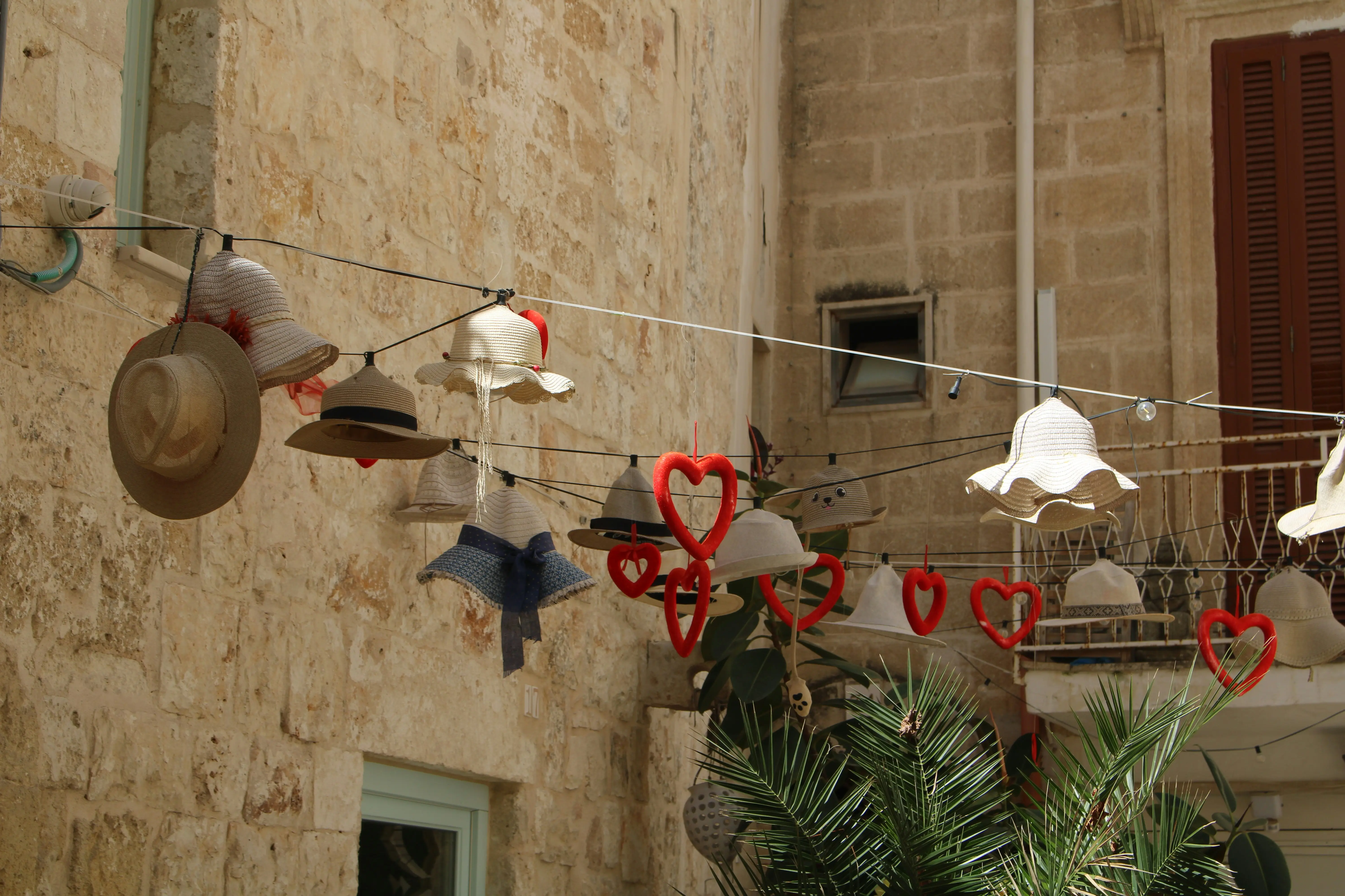 Hats and red hearts hanging on a string